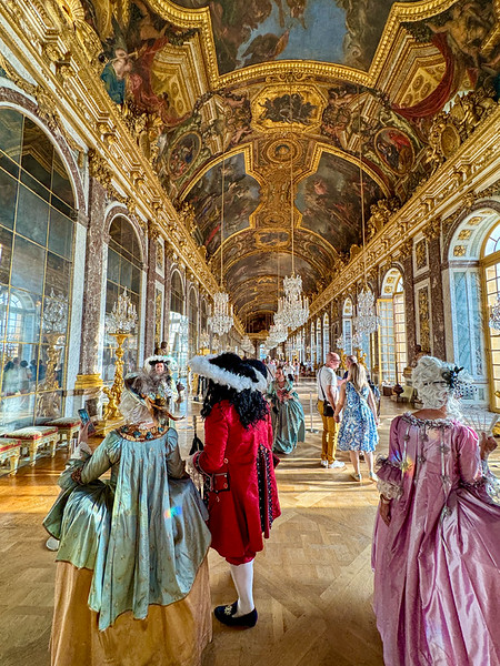 In costume in the Hall of Mirrors at Versailles